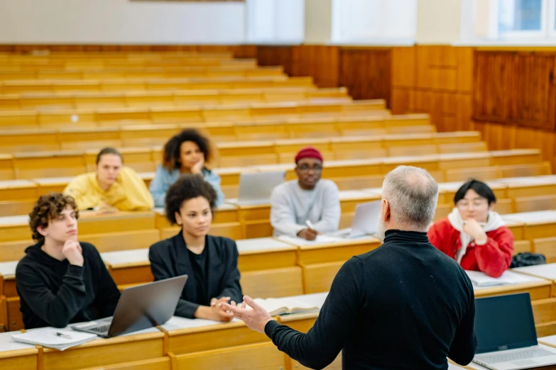 a lecture hall with students in it having a discussion