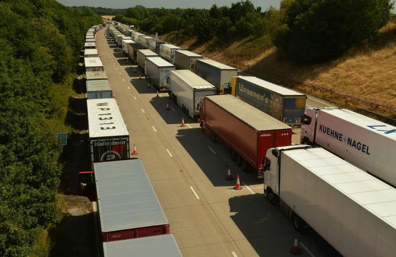 a highway filled with lots of parked semi trucks