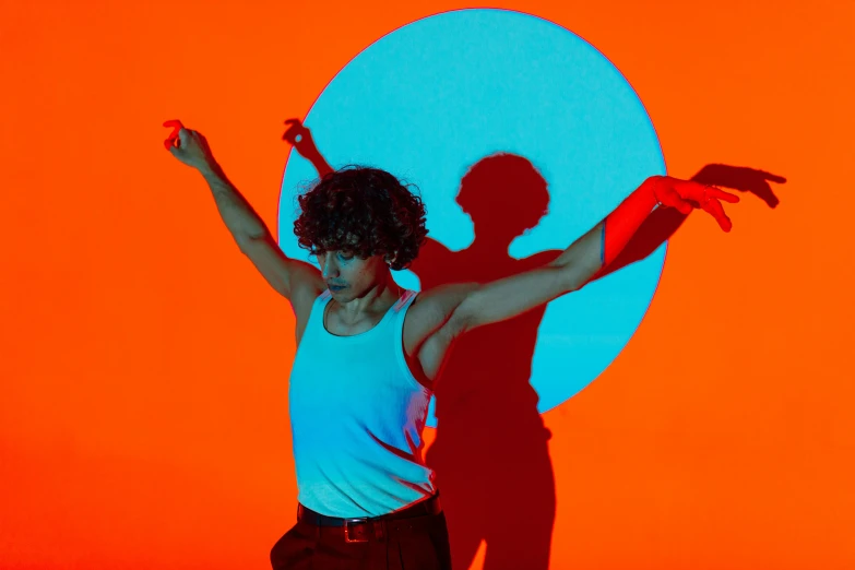 the silhouette of a person is overlaid in a white tank top and orange pants