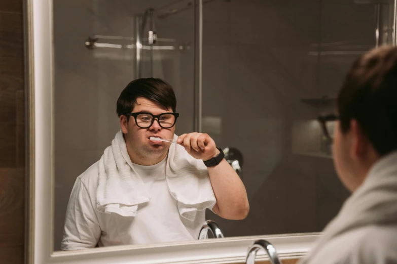 a man in white shirt brushing his teeth