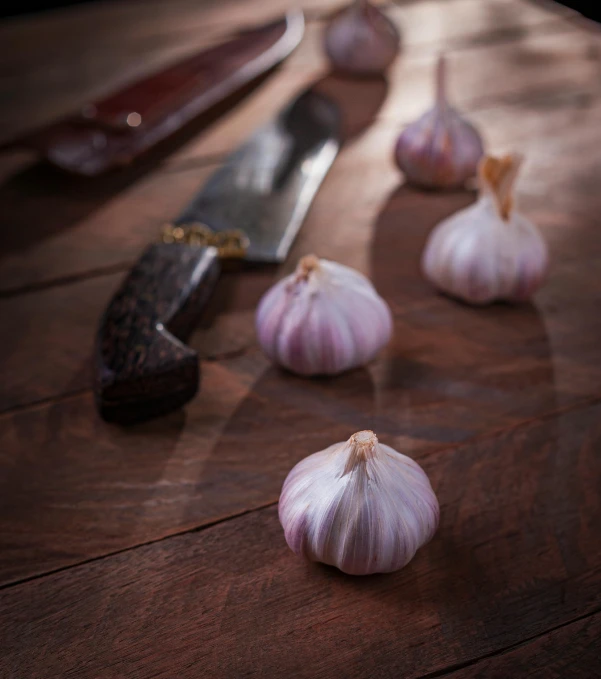 garlic on a table with knife and a knife