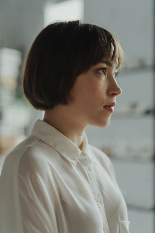 a young asian woman looking away while standing