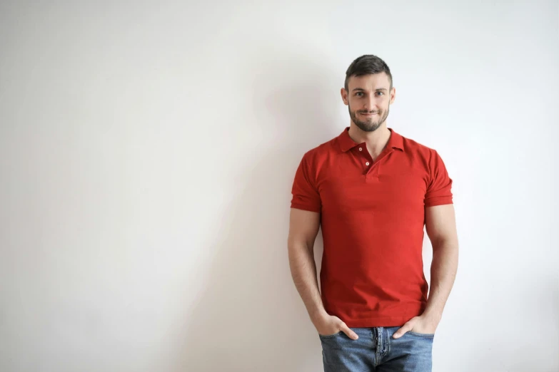 a man in a red shirt is posing for the camera