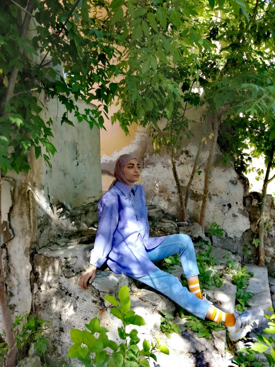 there is a doll sitting on some rocks in the shade