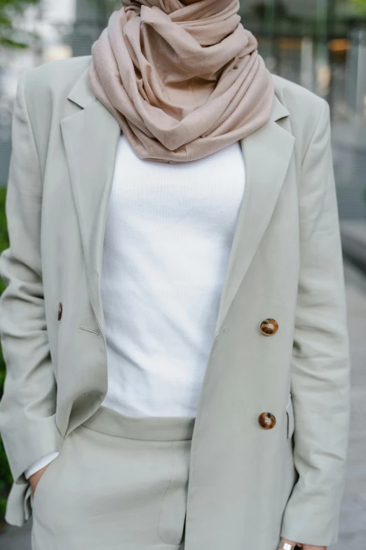 woman with light colored clothes and a beige jacket