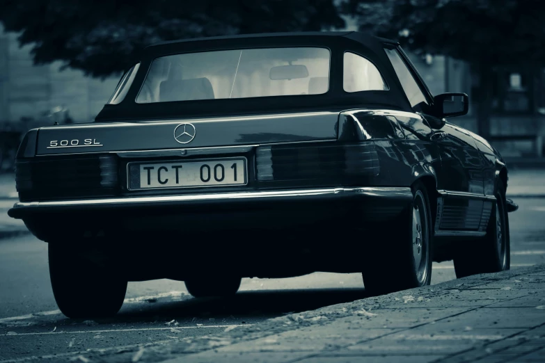 an old model, automobile is shown parked on the street