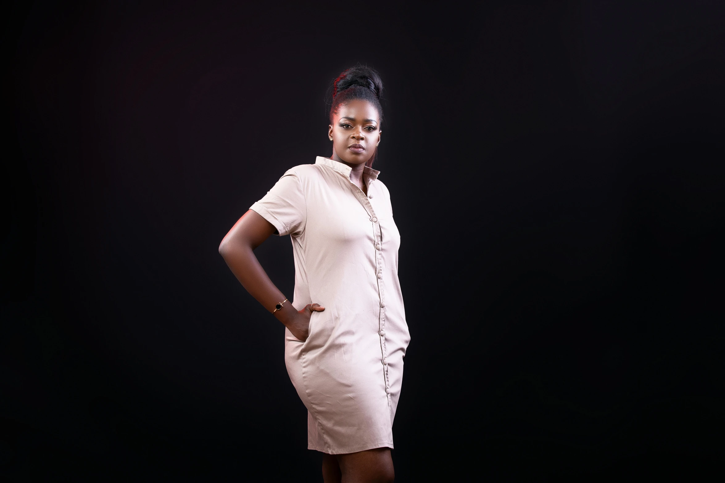 a woman posing for a po in front of a black background