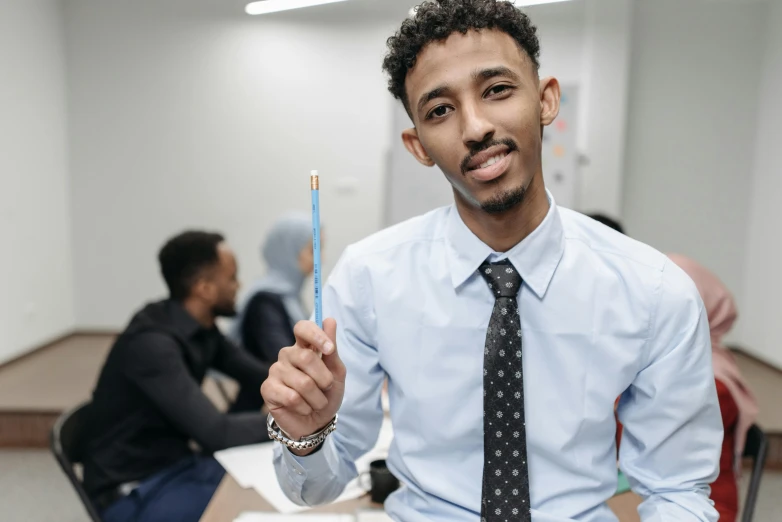 a man in a tie and dress shirt posing with his toothbrush