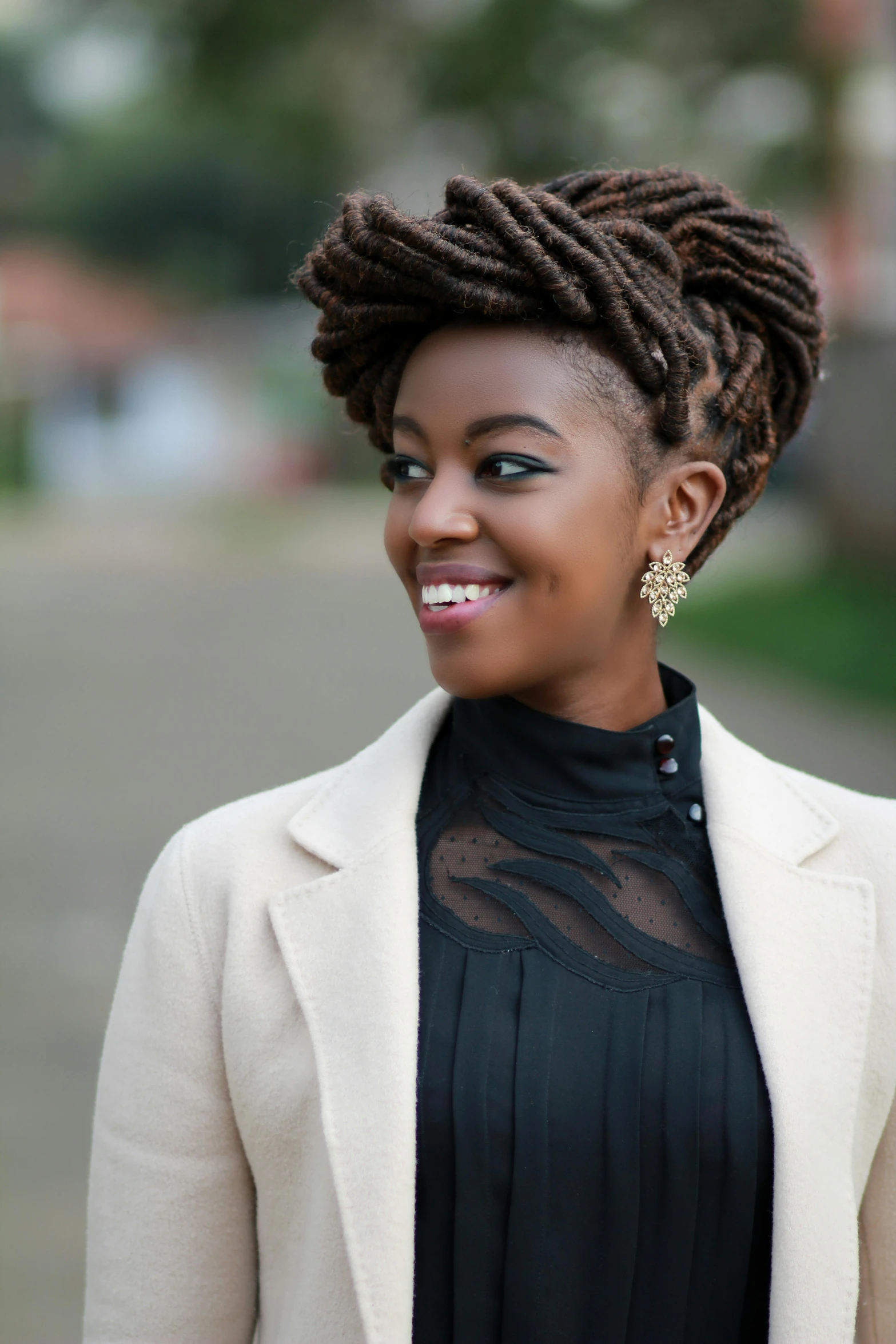 a woman with ids is smiling and wearing a black shirt