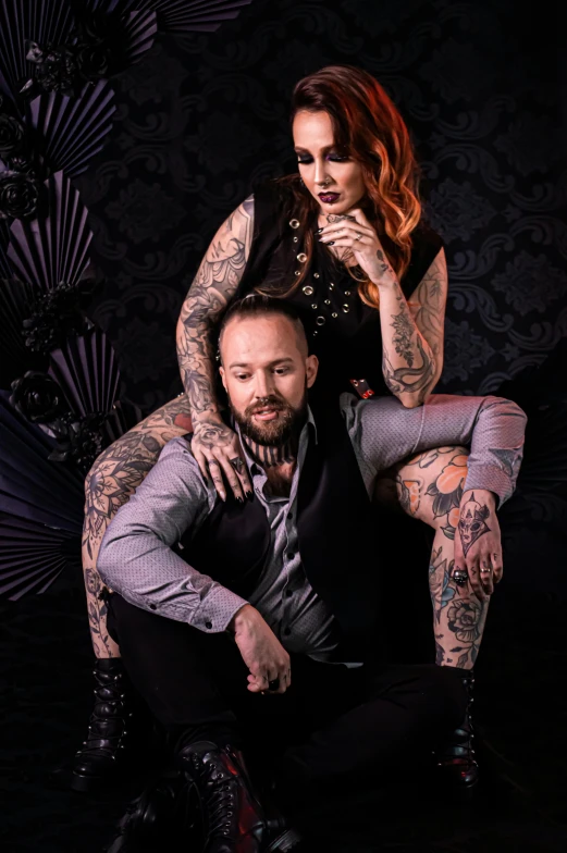 a woman with a tattoo and two men wearing matching tattoos