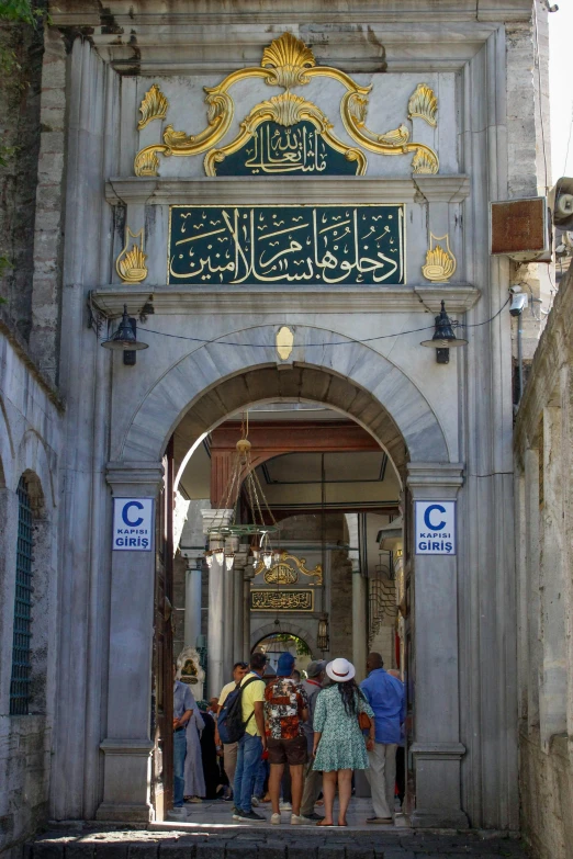 a group of people are entering an archway