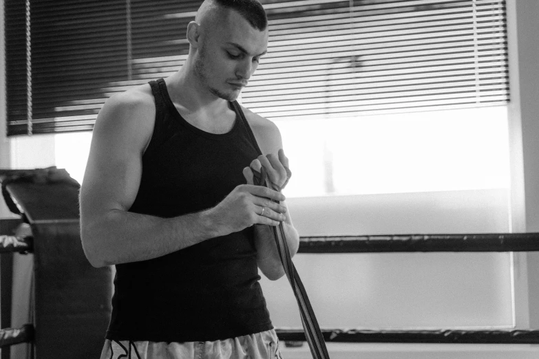 a man is holding a stick and ball in the gym