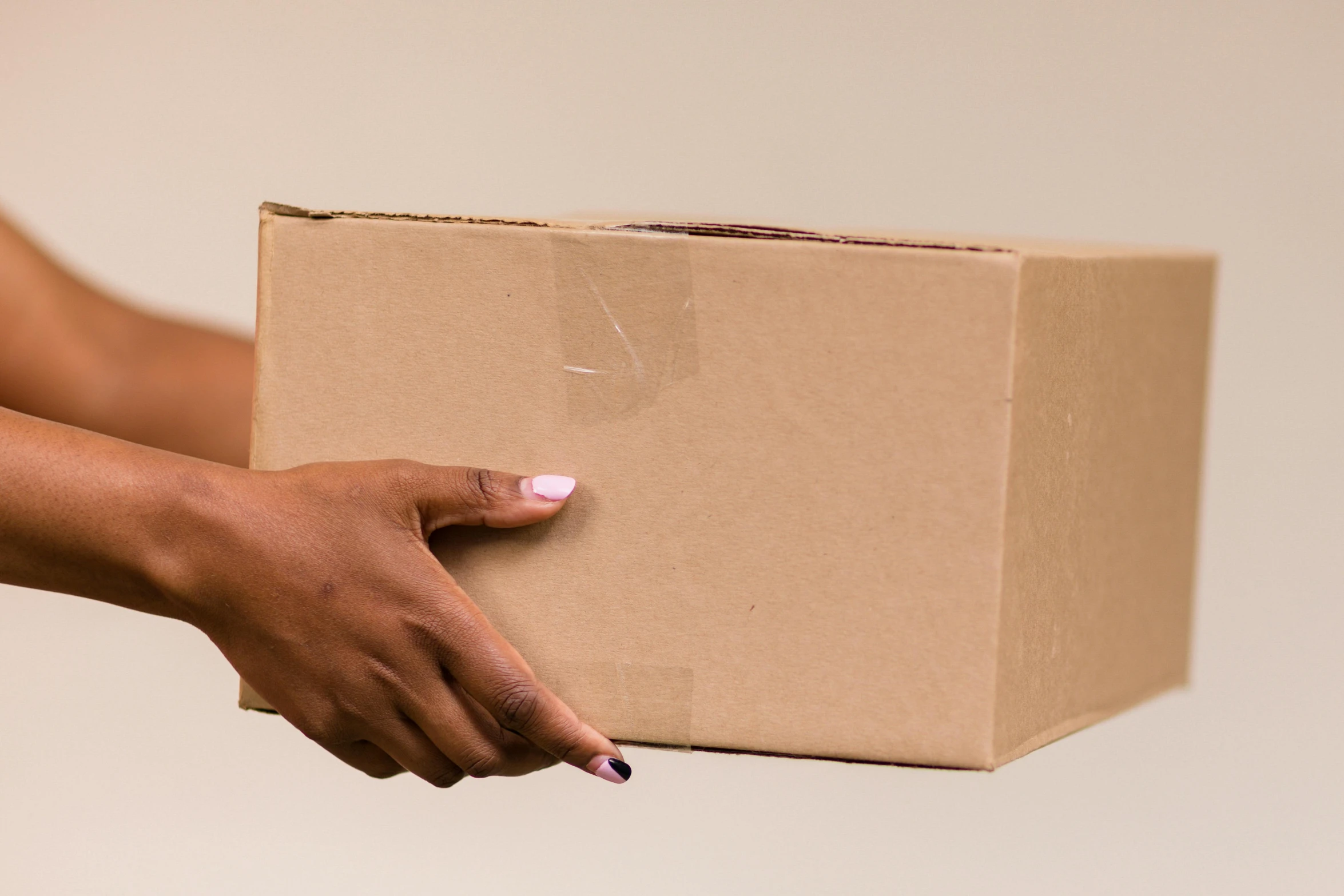 a person holding a box in a hand