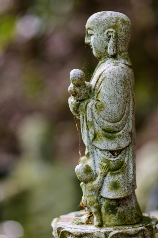 a stone statue with a bird perches on it