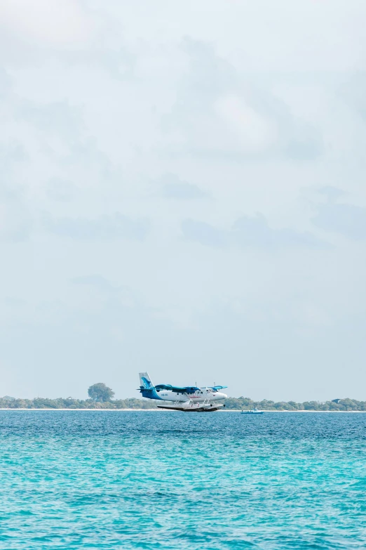 an airplane is flying low over a body of water