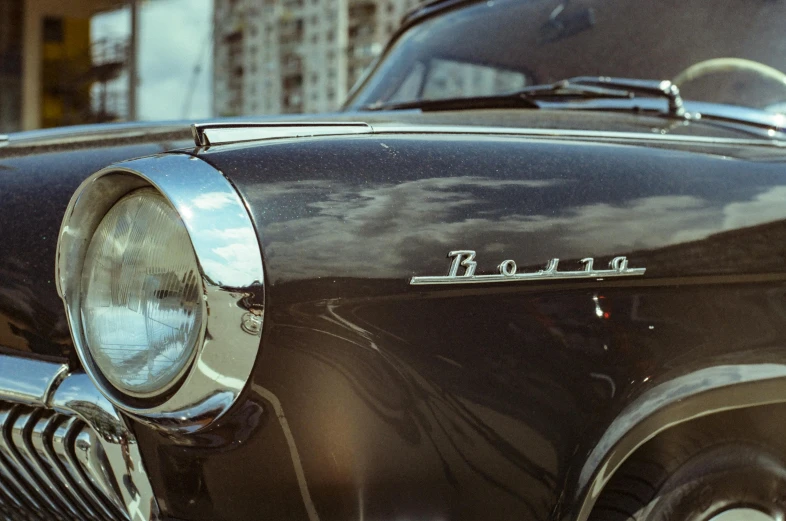 an old fashioned black car that is sitting on the street