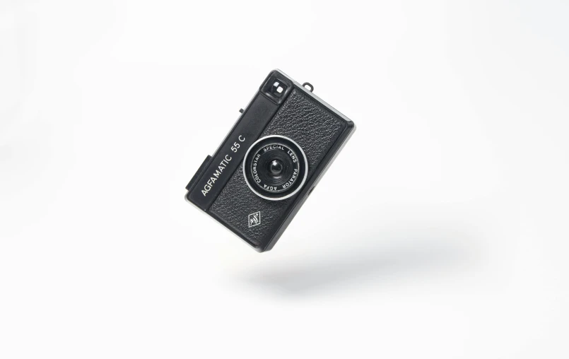 a camera that is flying on a white background