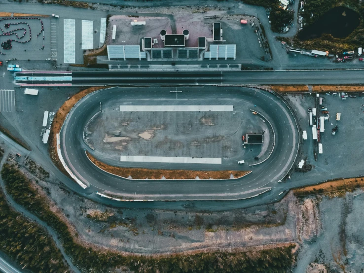 an aerial view of the race track with cars parked on the side of it