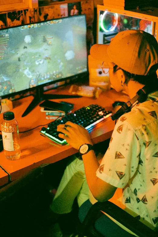 a boy using his computer in front of the flat screen tv