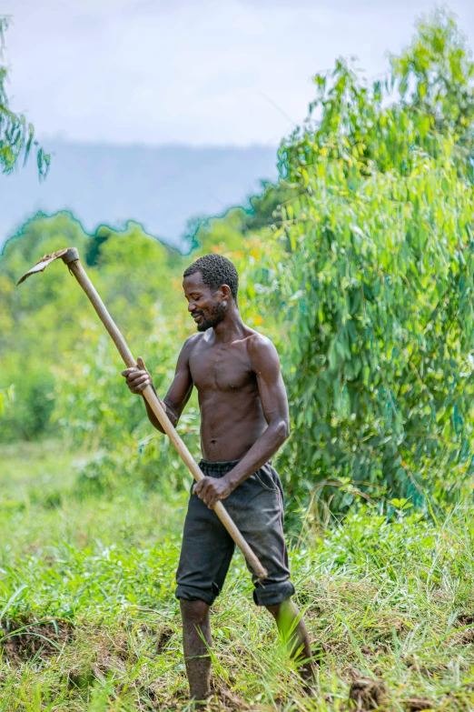 man wearing brown pants and holding large stick