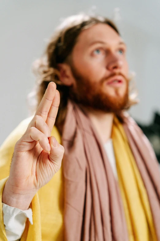 a man with a long hair is pointing