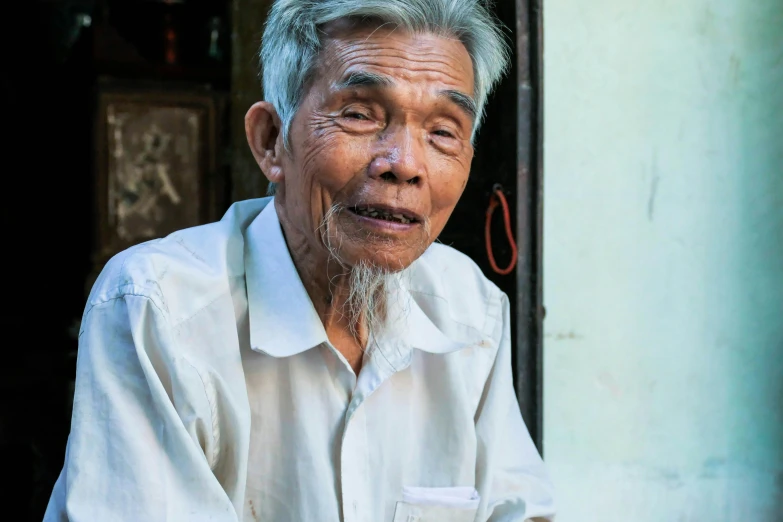 a man in white shirt with gray hair