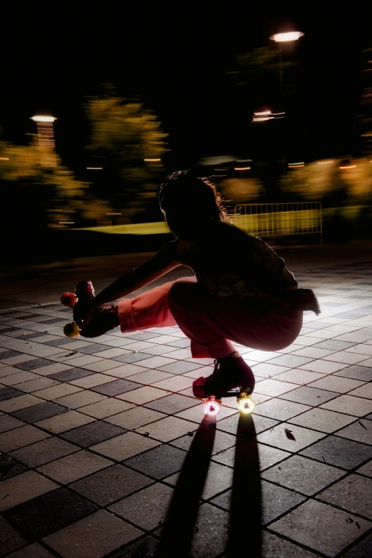 skateboarder doing trick with dark background