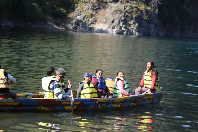 some people sitting in a boat going down the river