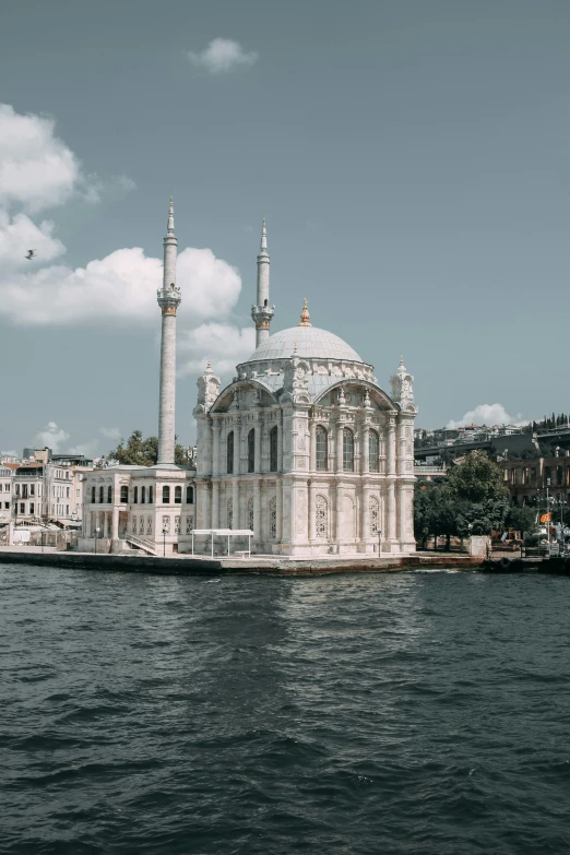 a large building sits near a body of water