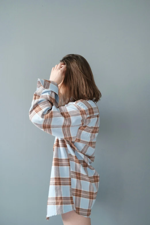 woman wearing plaid shirt posing for a po