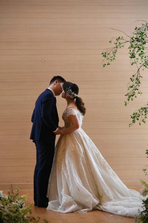 a man and a woman in wedding dress kissing