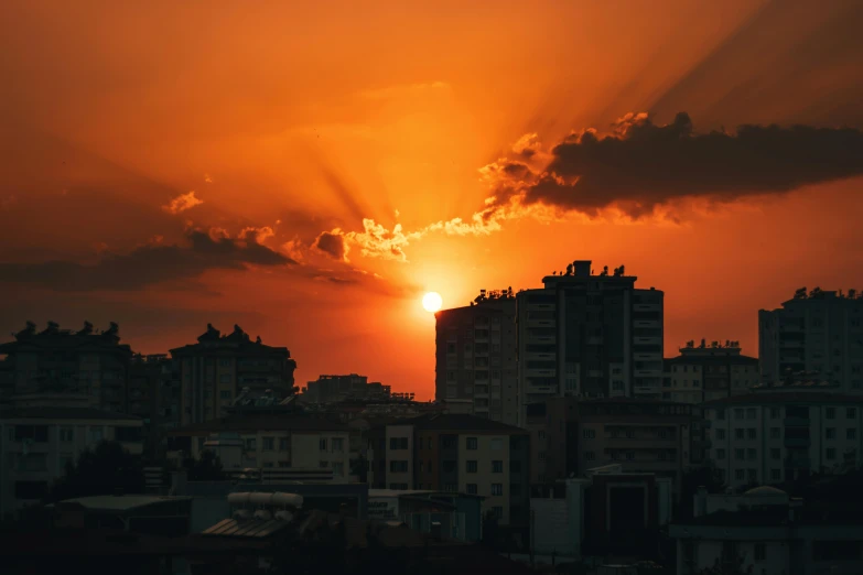 the sun is setting over a city skyline