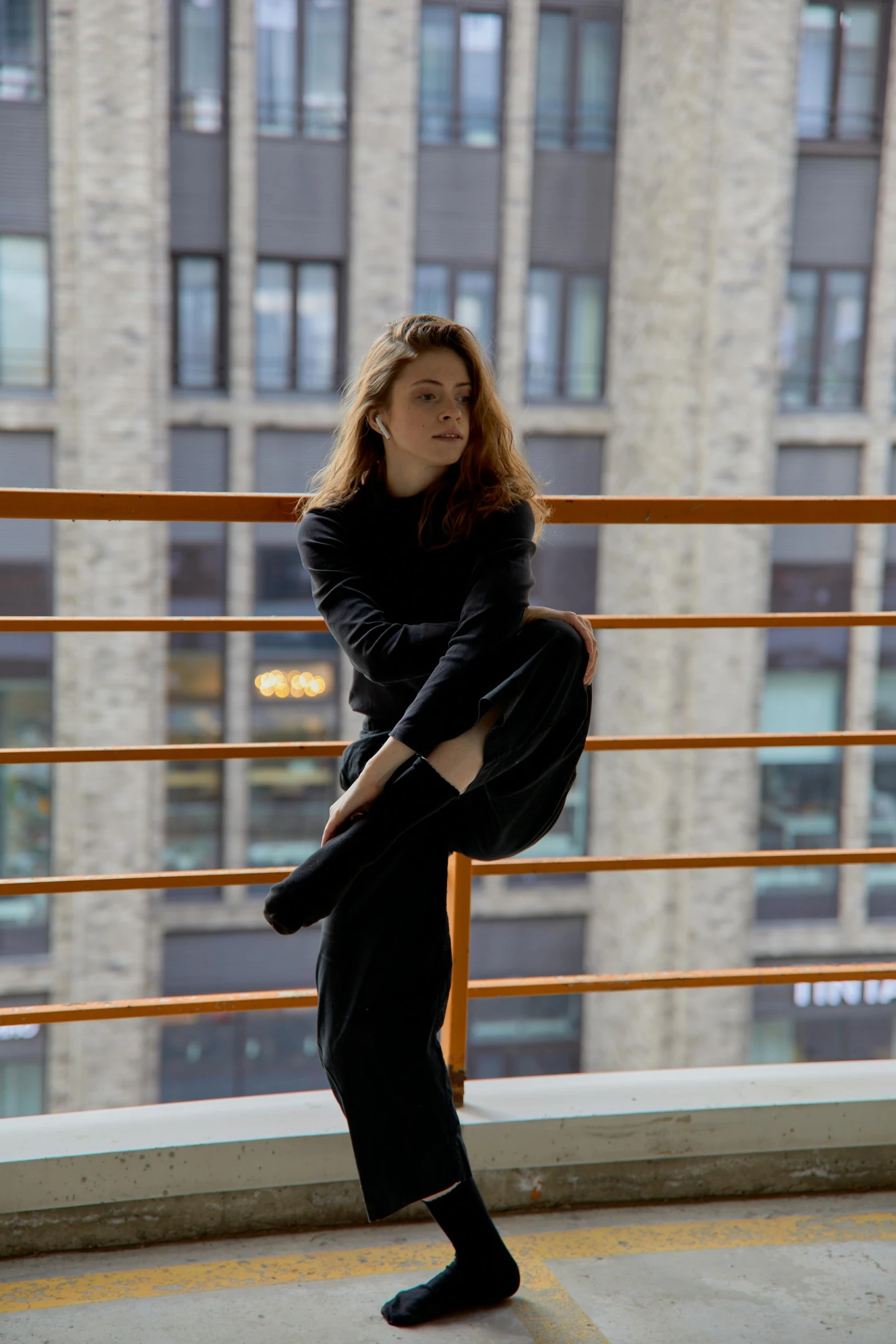 a woman doing exercises in front of a building