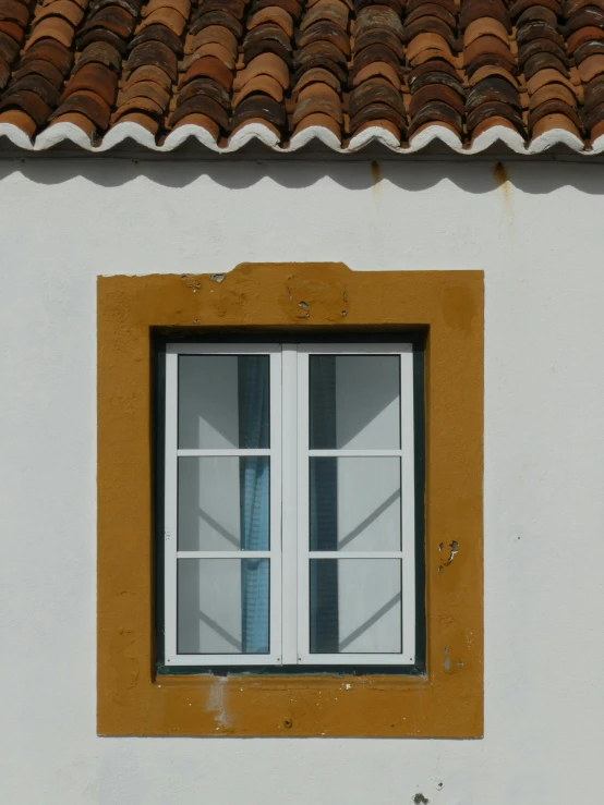 a window with a tile roof and a brick skylight