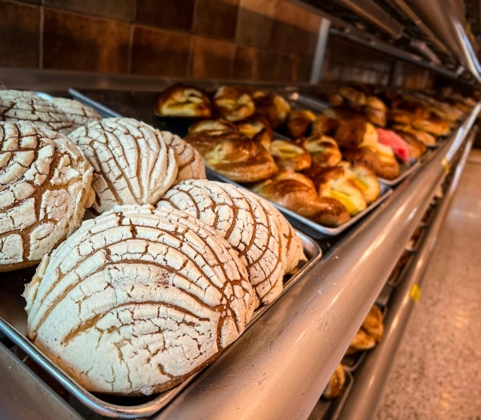 many different types of pastries sitting on a counter