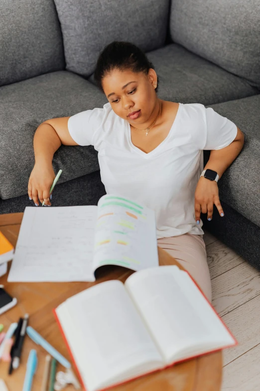 the young woman is studying in her home