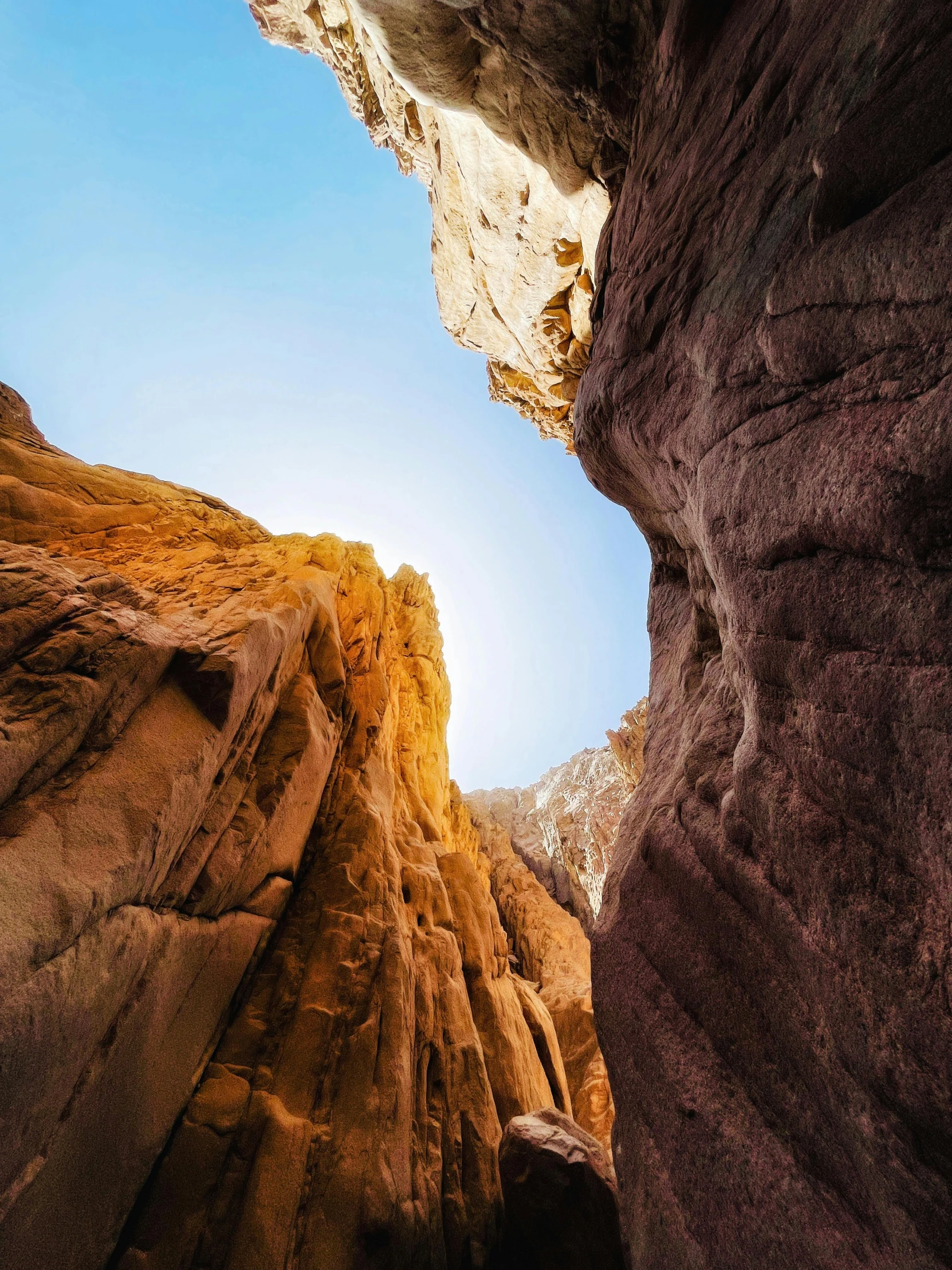 the side of a rock wall with a person standing under it