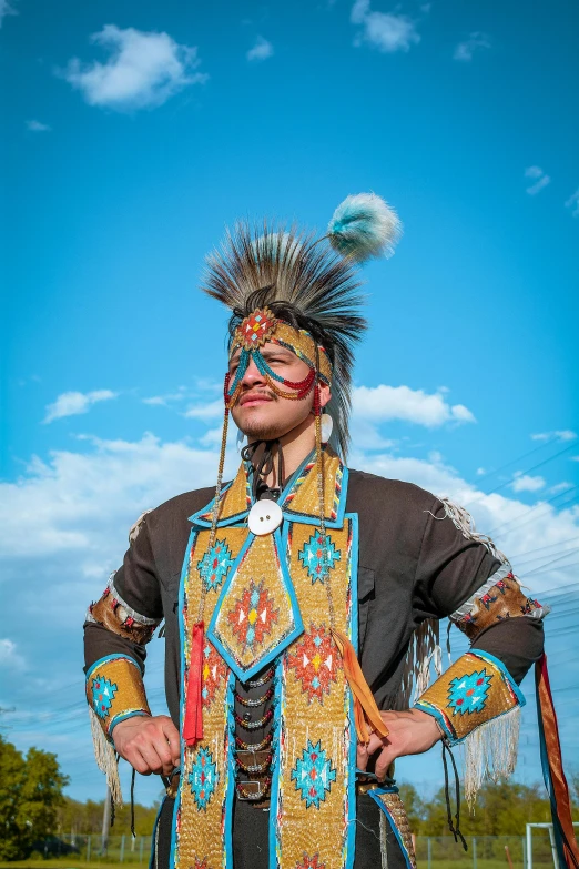 the indian is standing on the street in a bright outfit