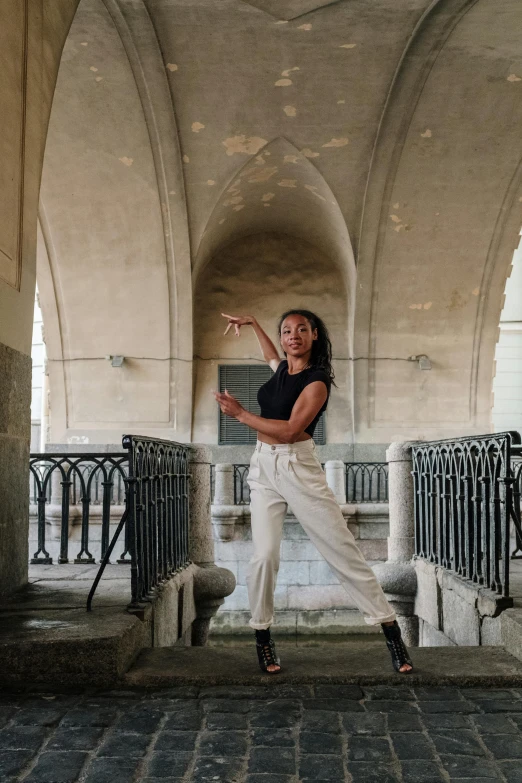 the young woman is in a tunnel posing for the camera