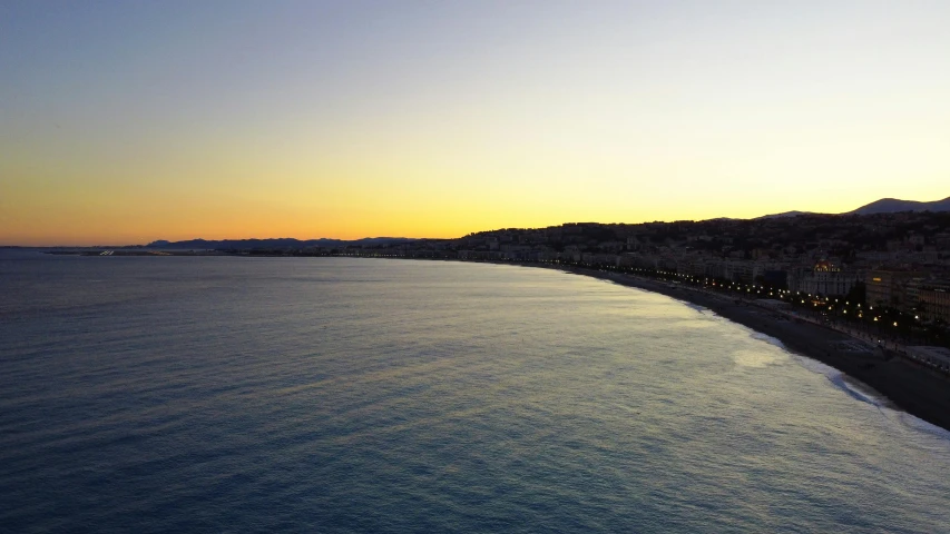 a view of the beach from across the ocean