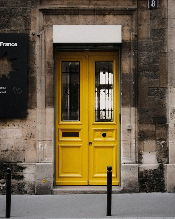 the yellow door of this building has been painted