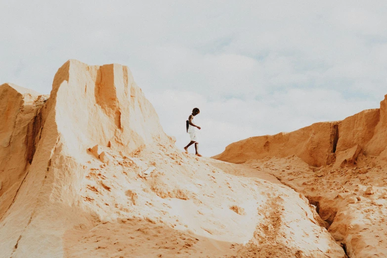 man walking in the desert and looking out