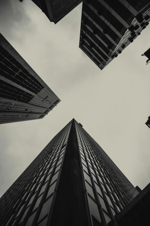 looking up at three tall buildings in the city