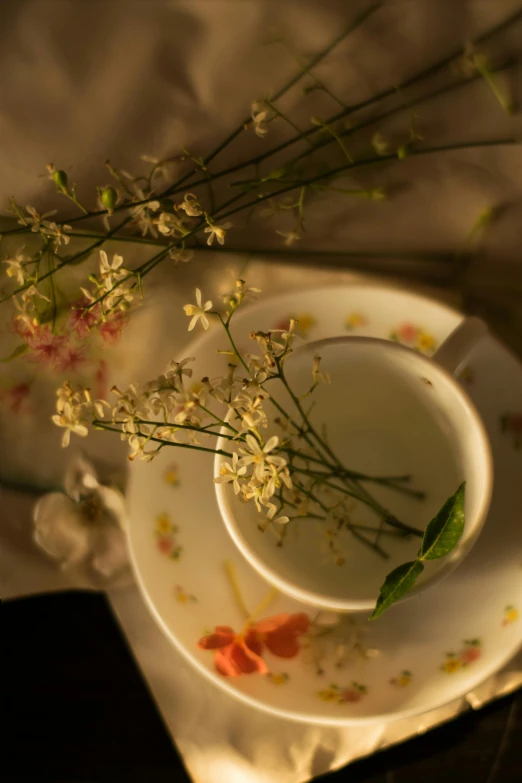 small white vase with fresh flowers on a plate