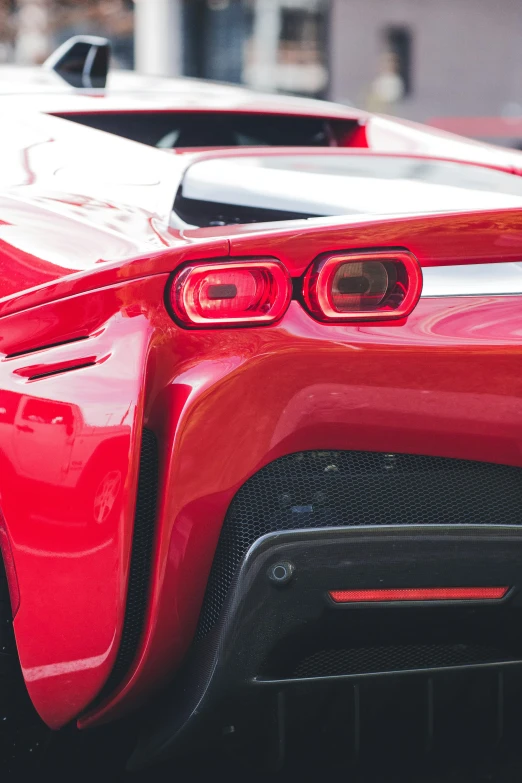 a close up of the back end of a red car