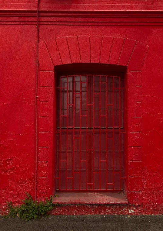 an old window is in the corner on a red building