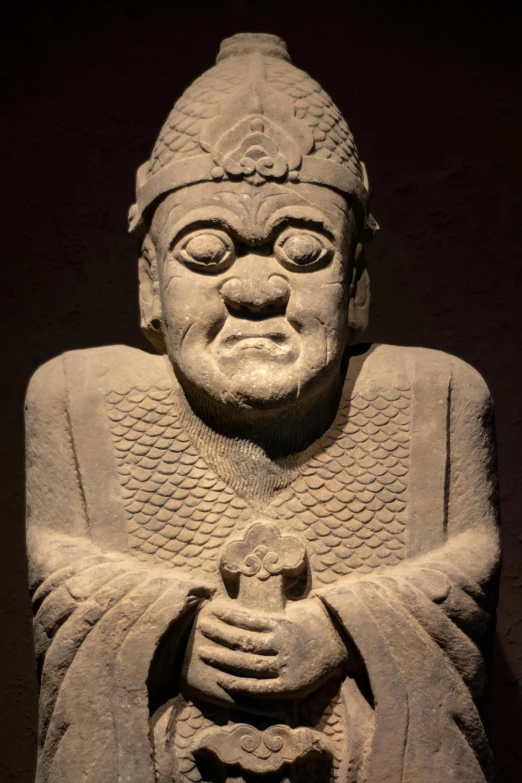 an old statue that is in the shape of a man with his hands under his chin