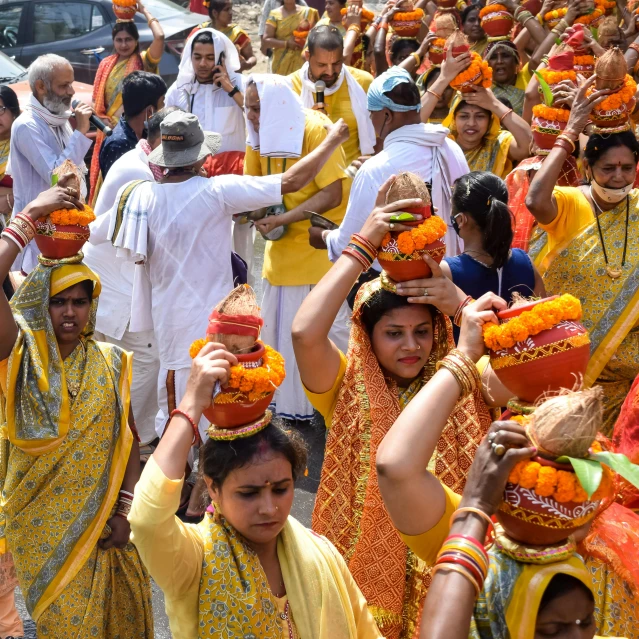 a group of people standing around each other in colorful costumes