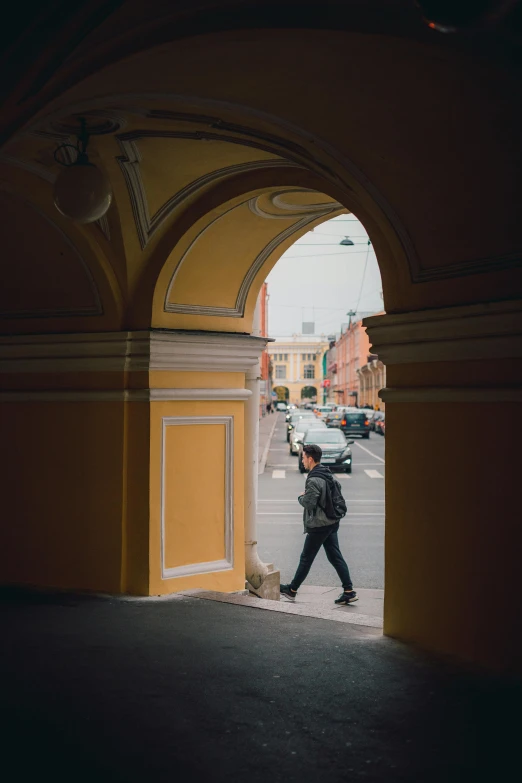 a man walking into a door way under a sky light