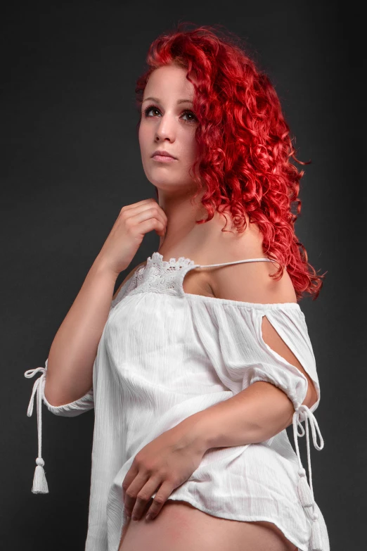an attractive woman with red hair wearing an off the shoulder top
